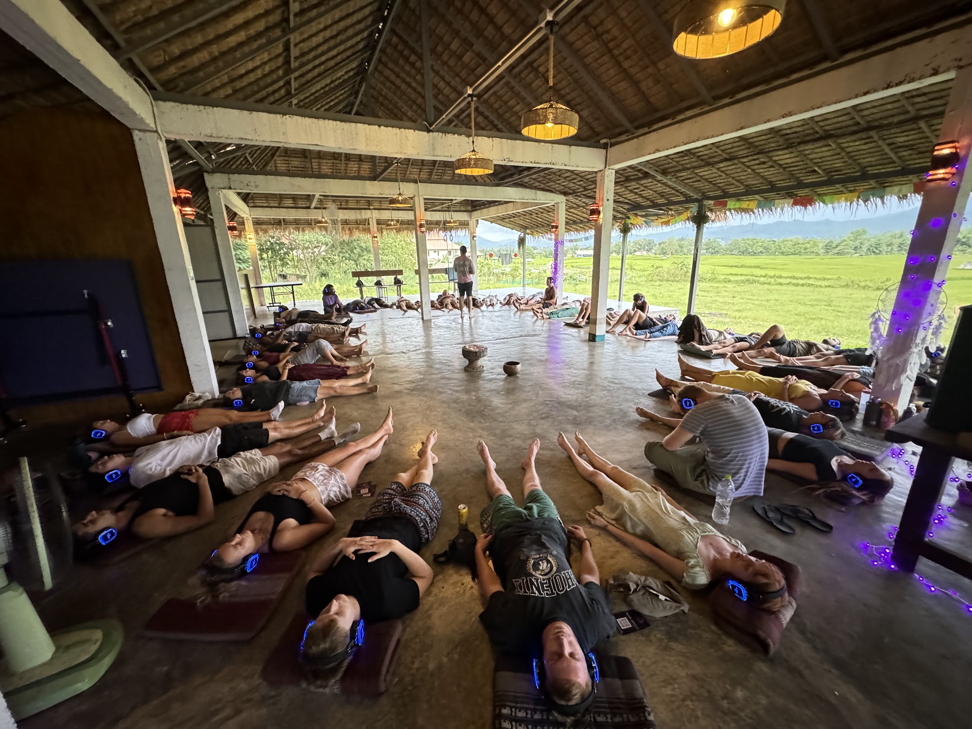 A Mind Artists workshop. A roomful of people lying on the floor with headphones, eyes closed, in a guided hypnosis.
